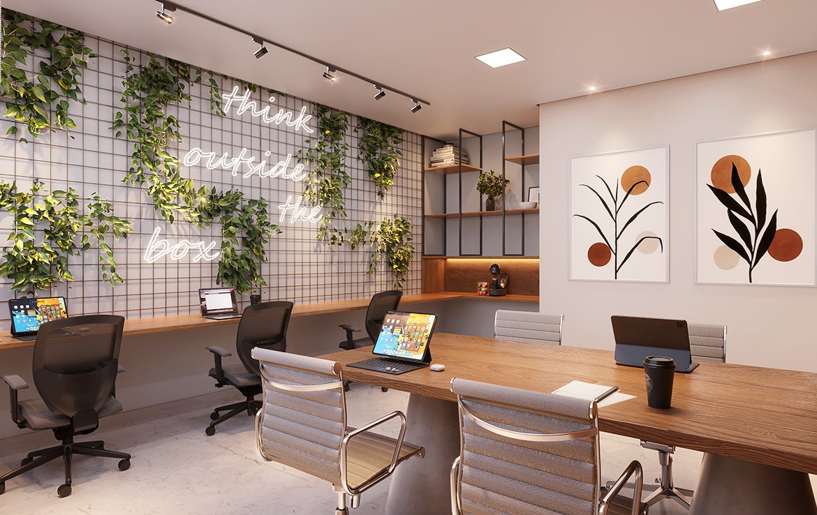 Coworking do edificio Pier Boulevard com mesa e cadeiras modernas, bancada com 03 cadeiras pretas e confortáveis decorada com quadros e painel com folhas verdes como decoração