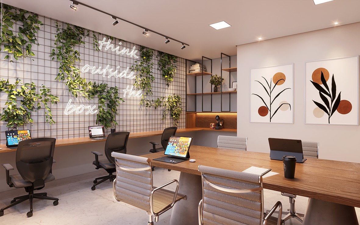 Coworking do edificio Pier Boulevard com mesa e cadeiras modernas, bancada com 03 cadeiras pretas e confortáveis decorada com quadros e painel com folhas verdes como decoração